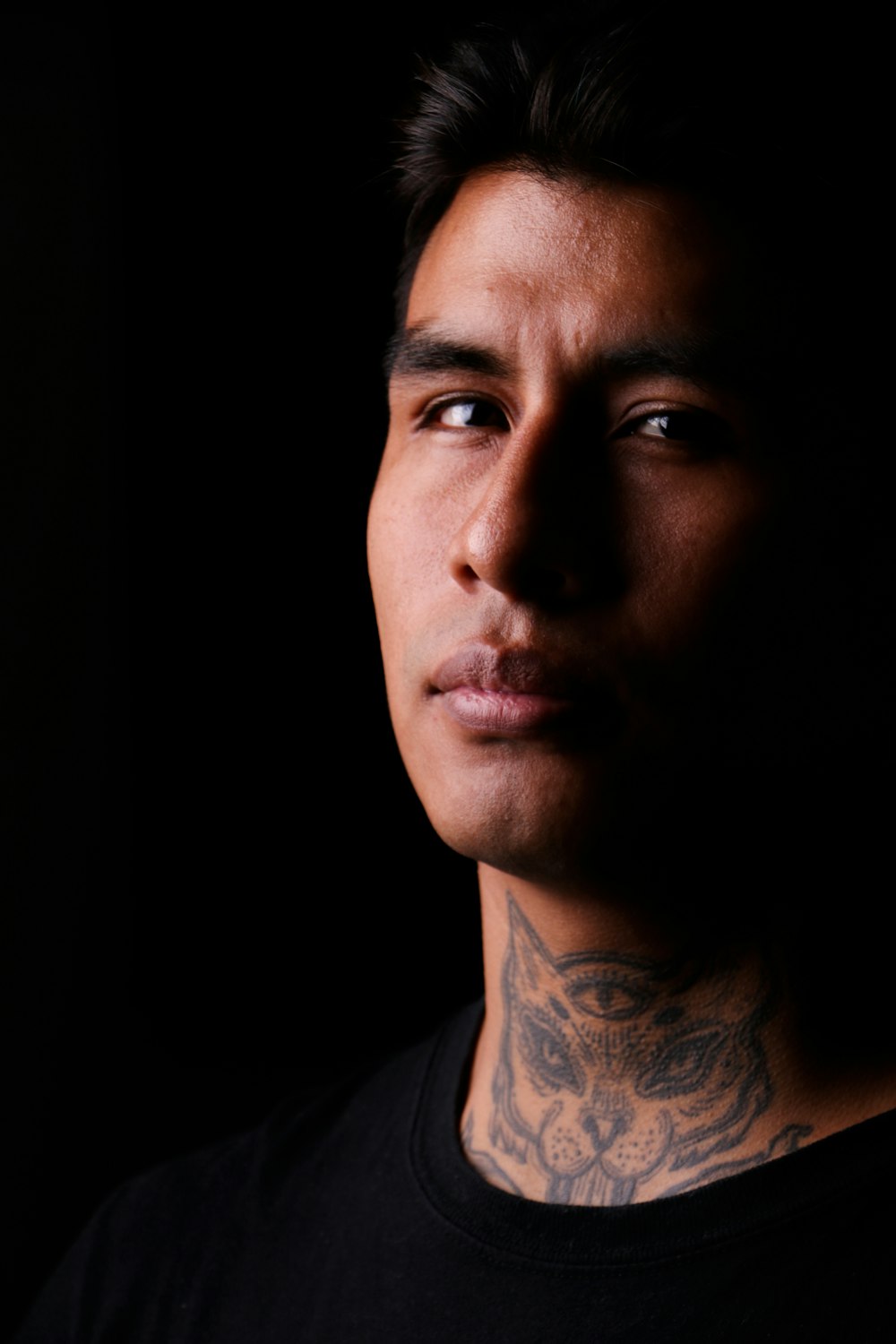 a close up of a person with a tattoo on his neck