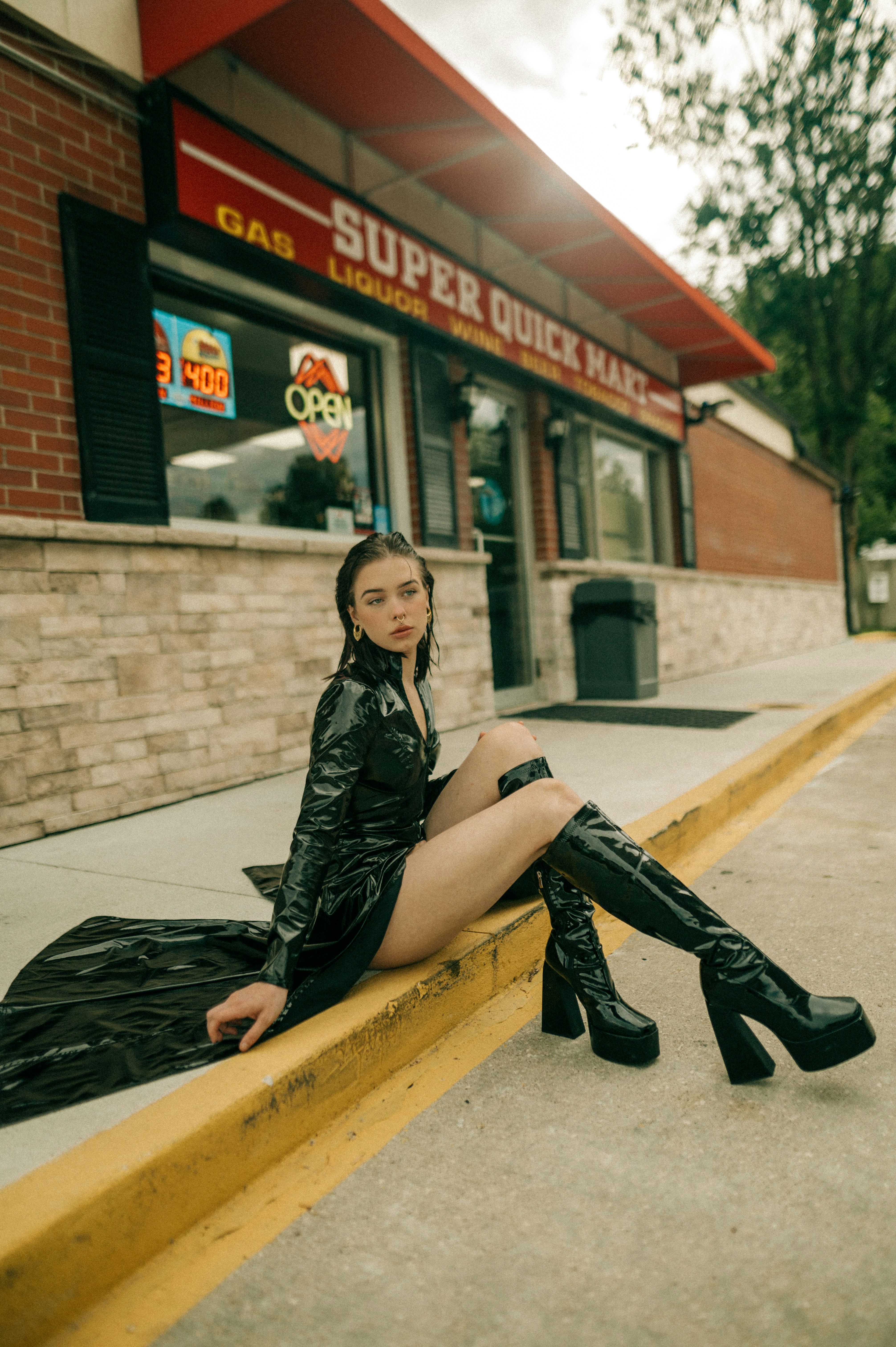 a woman sitting on a ledge outside of a restaurant