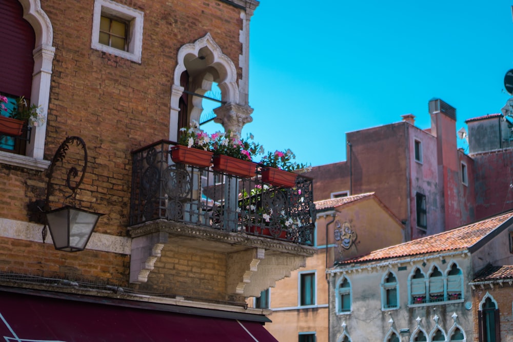 a building with a balcony with flowers on it