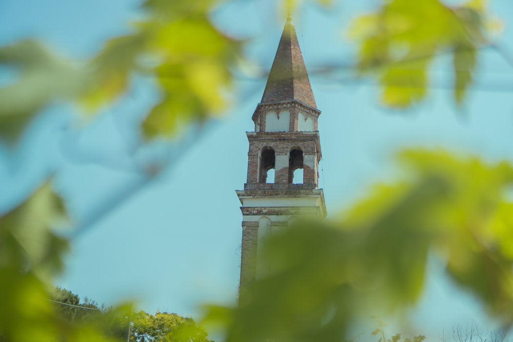 a tall clock tower with a clock on each of it's sides