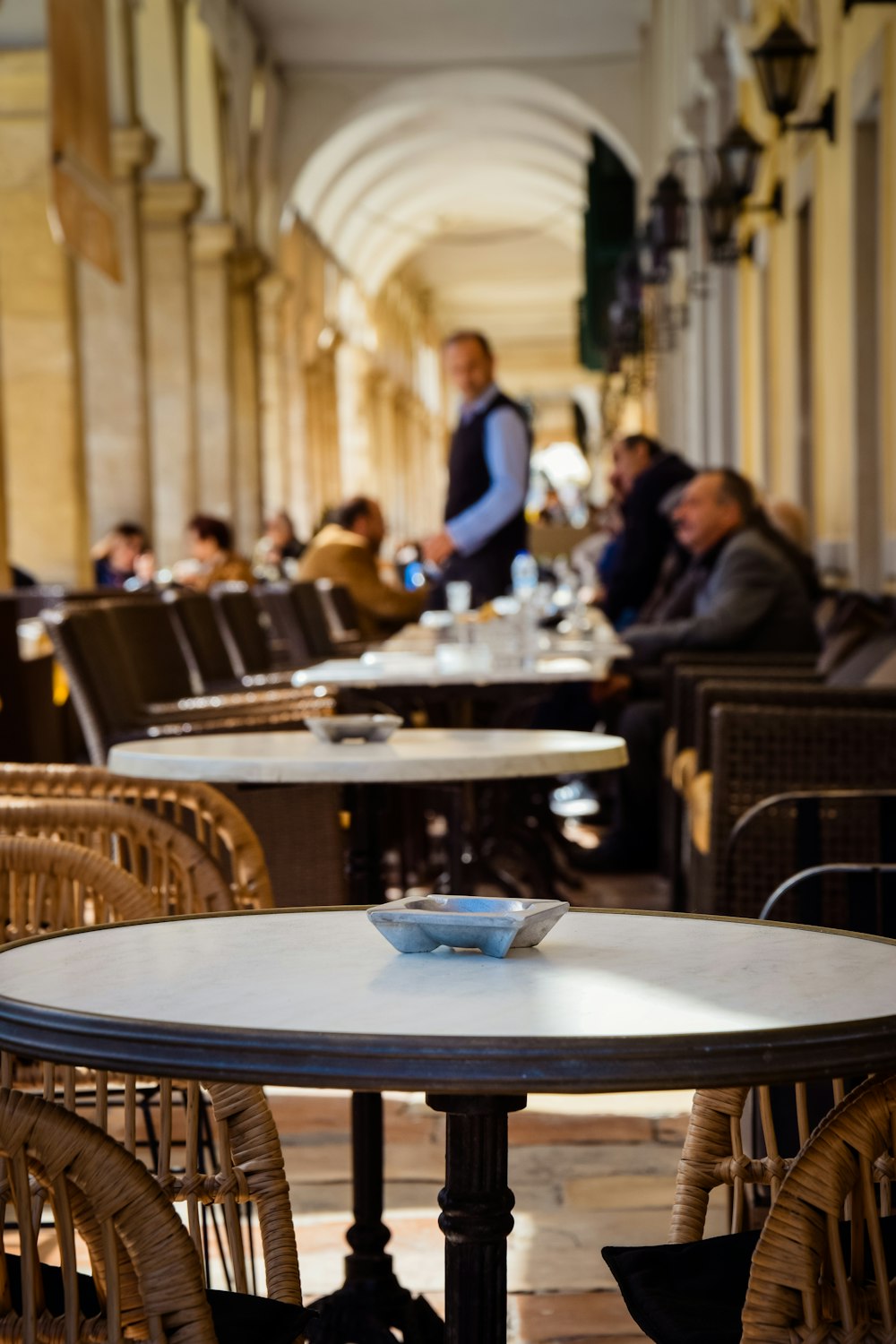 a group of people sitting at tables in a restaurant