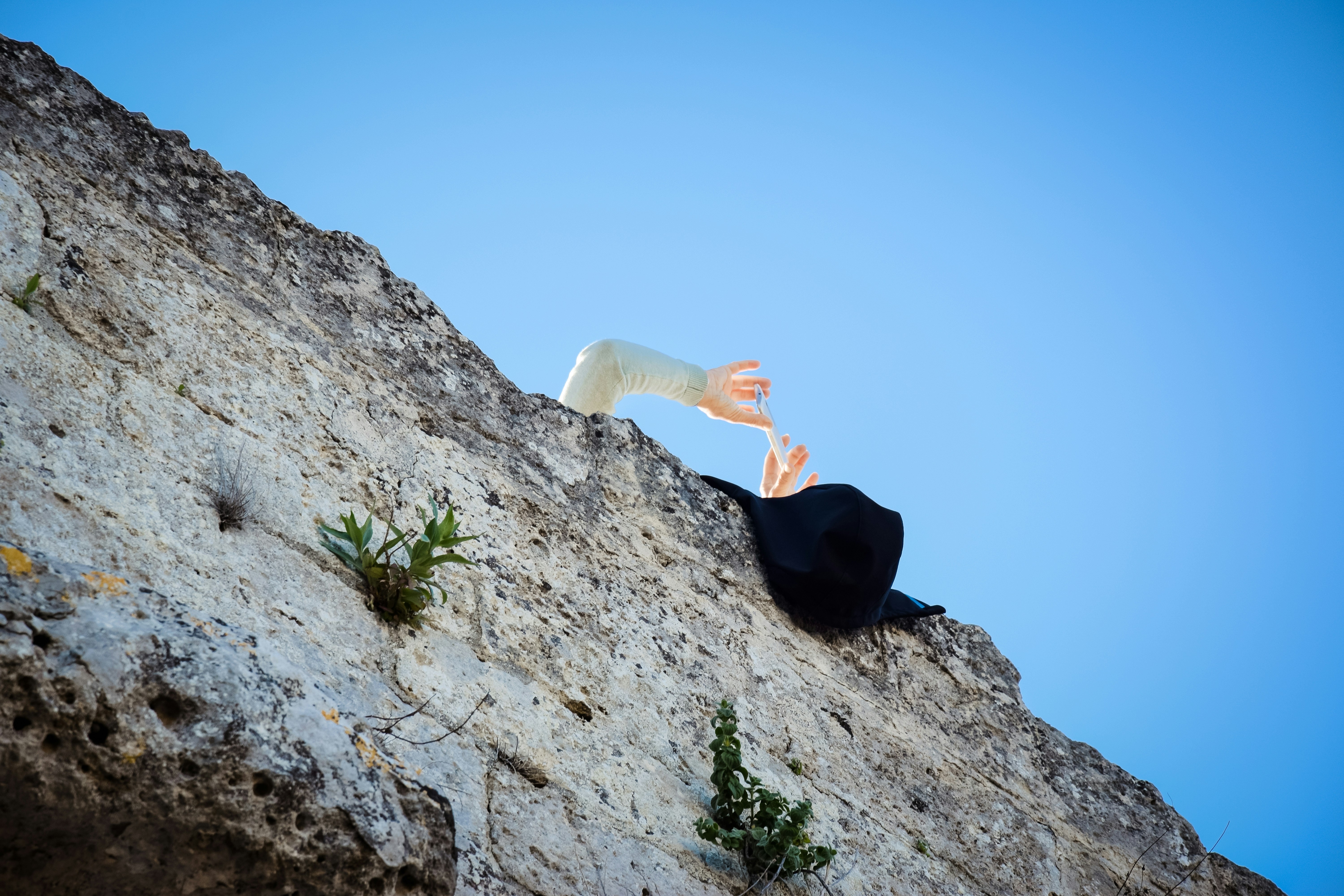 A close-up of a climber's hands and chalk