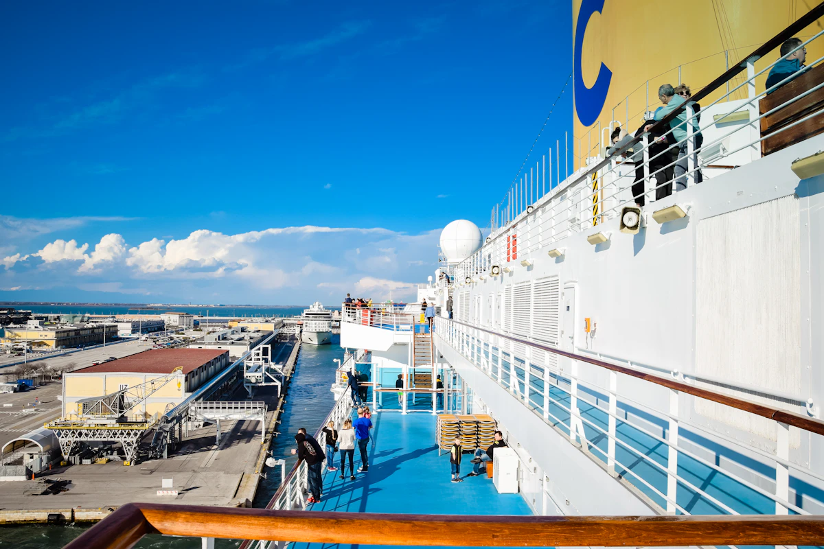Passengers walking along the deck of a cruise ship