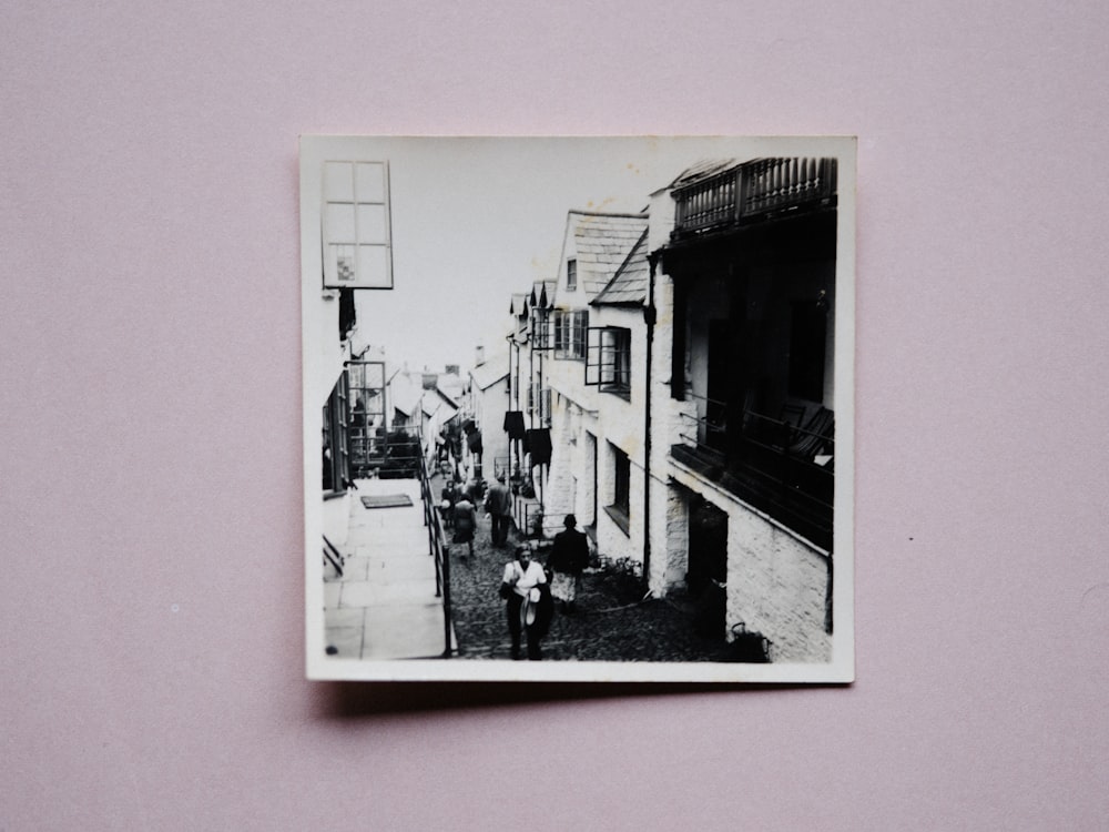 a black and white photo of people walking down a street