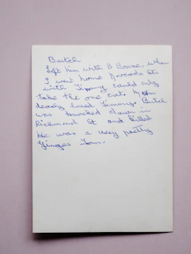 A serene cream-toned background with a handwritten note and a black pen resting beside it.