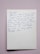 Close-up of a handwritten note with a heartfelt message on pastel pink paper.