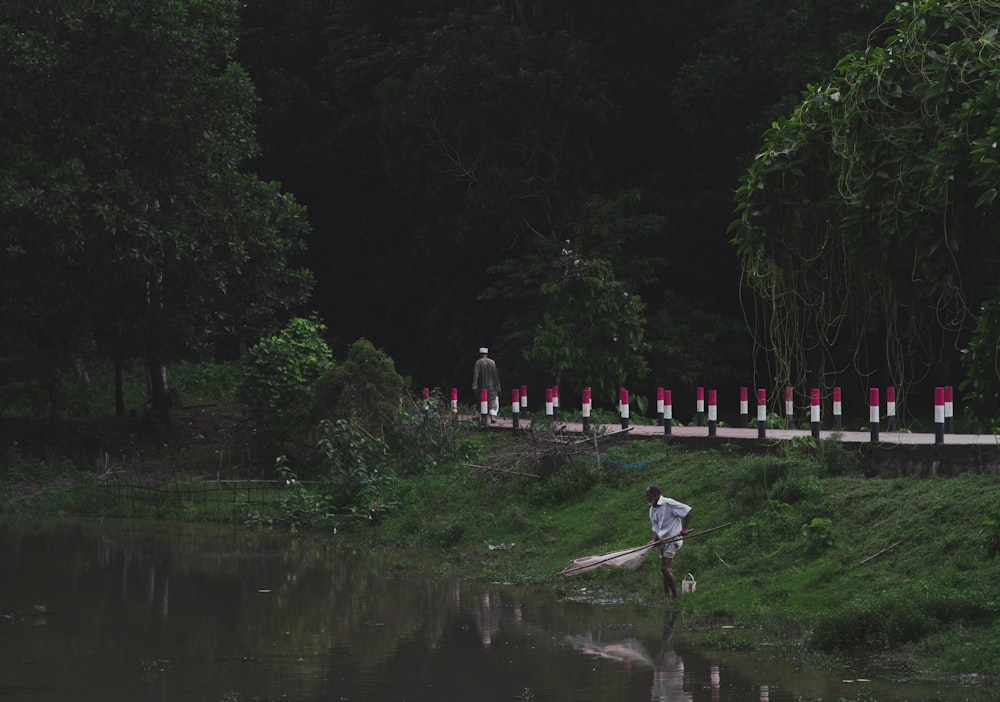 Un uomo che va in bicicletta lungo un fiume vicino a una foresta