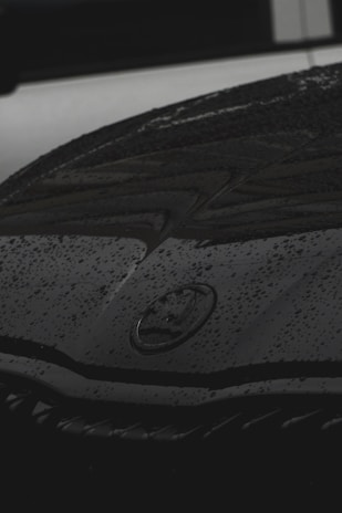 Close-up of water droplets beading perfectly on a freshly waxed car hood.