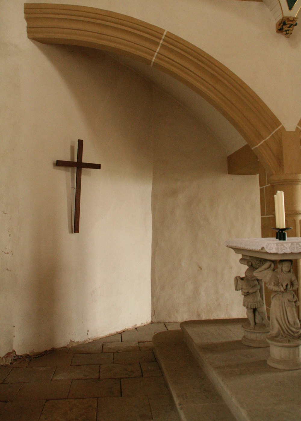 a cross hanging from the ceiling of a church