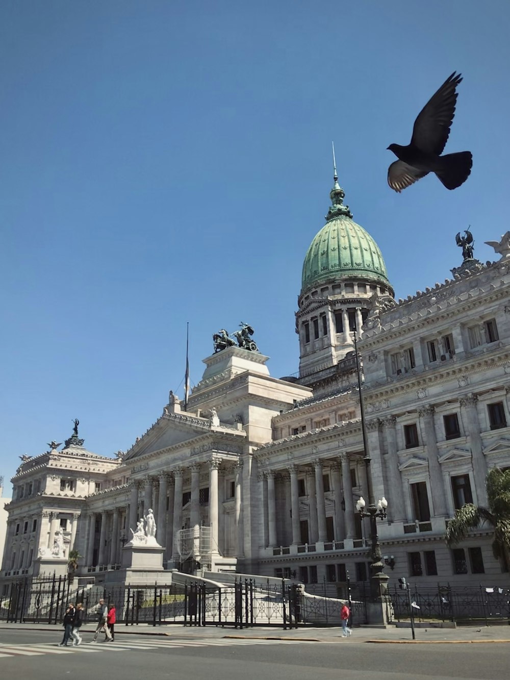 a bird flying in front of a large building