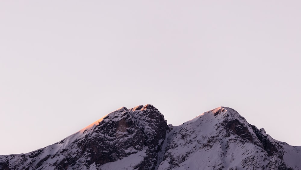 a snow covered mountain with a sky background