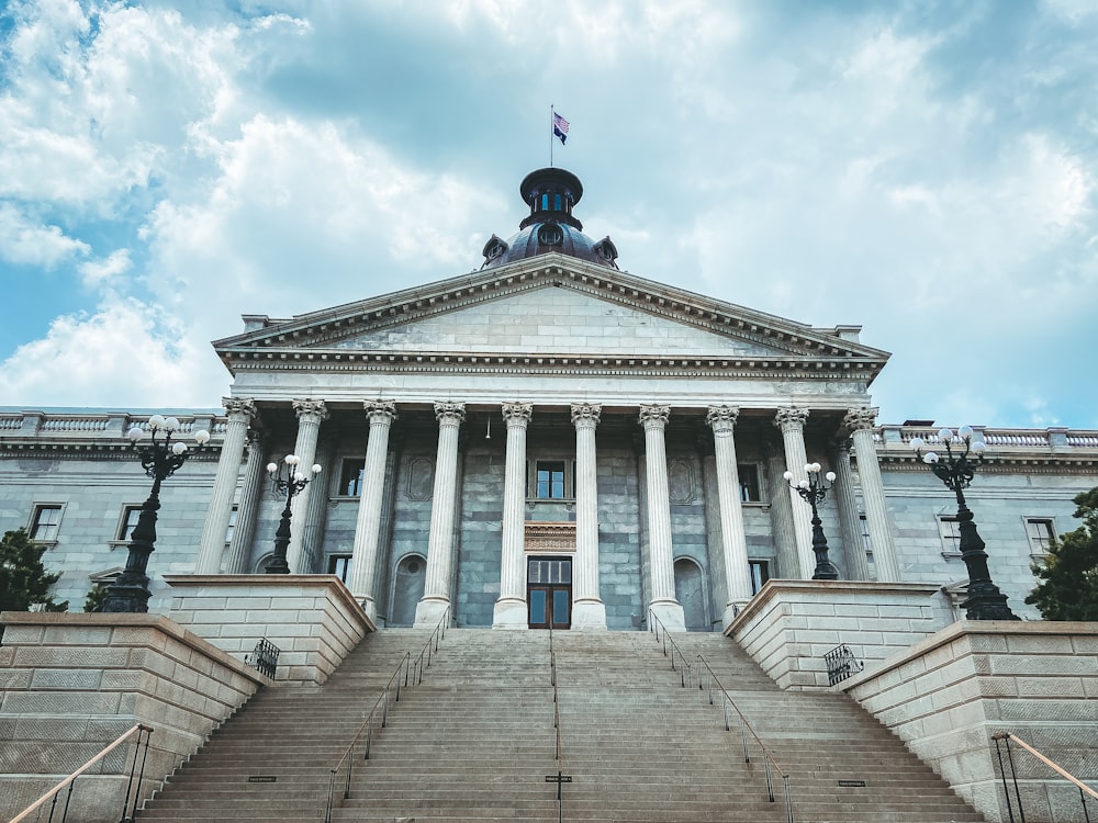 a large building with columns and a flag on top