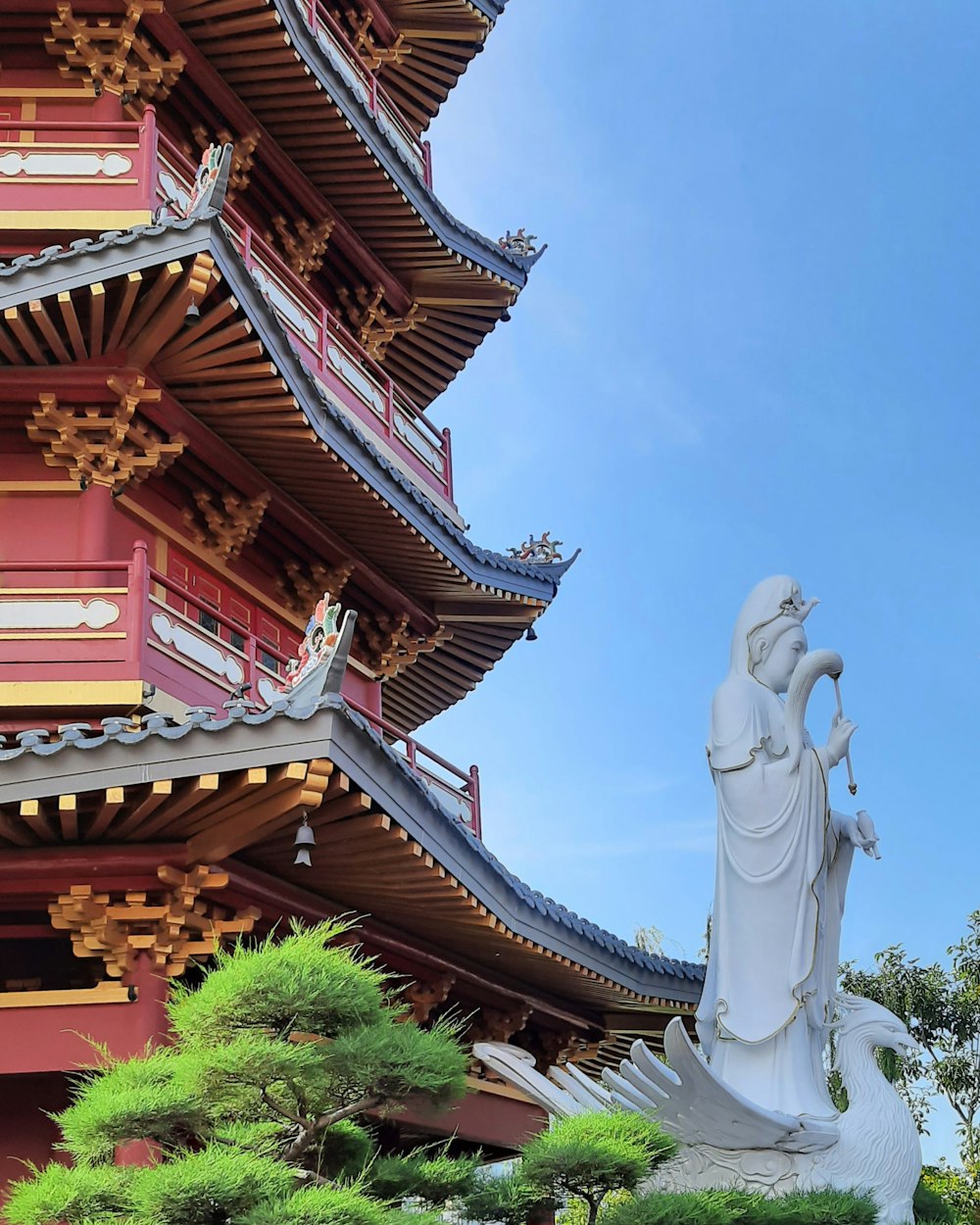 a tall building with a statue in front of it