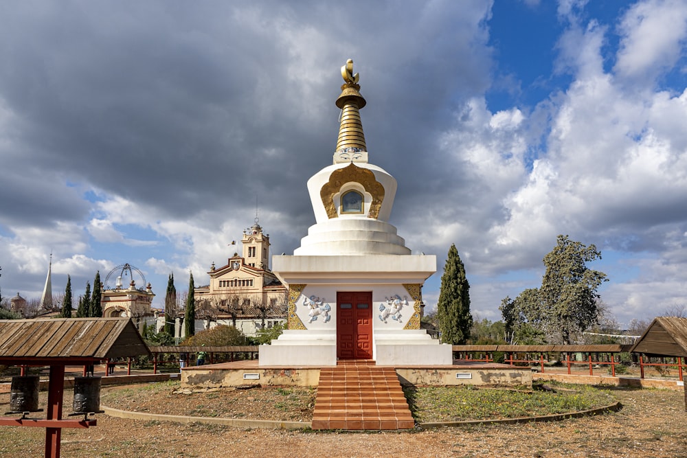 a large white and gold statue in a park