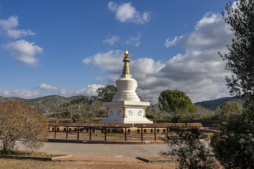 a white monument with a clock on top of it