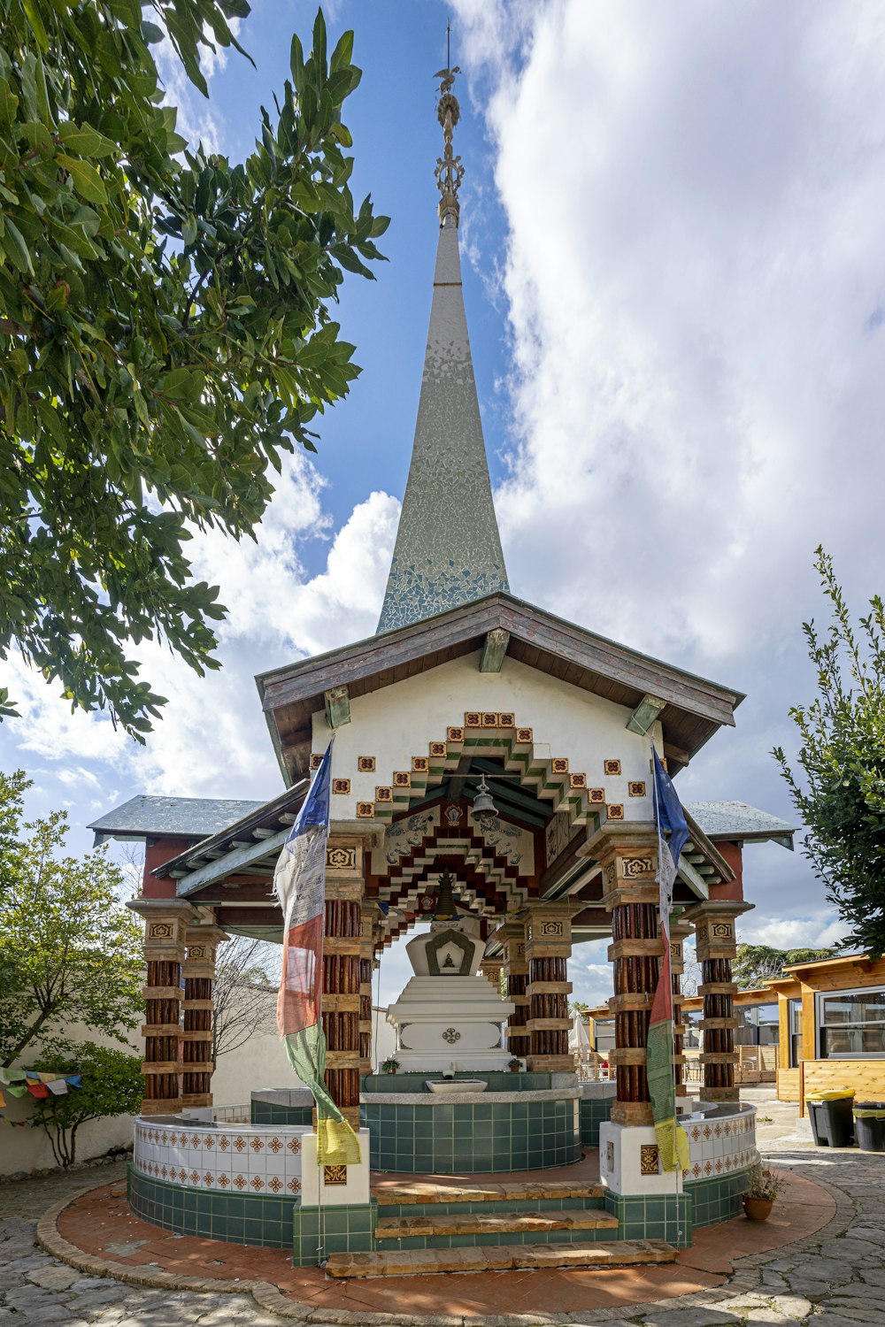 a small white and green building with a clock tower