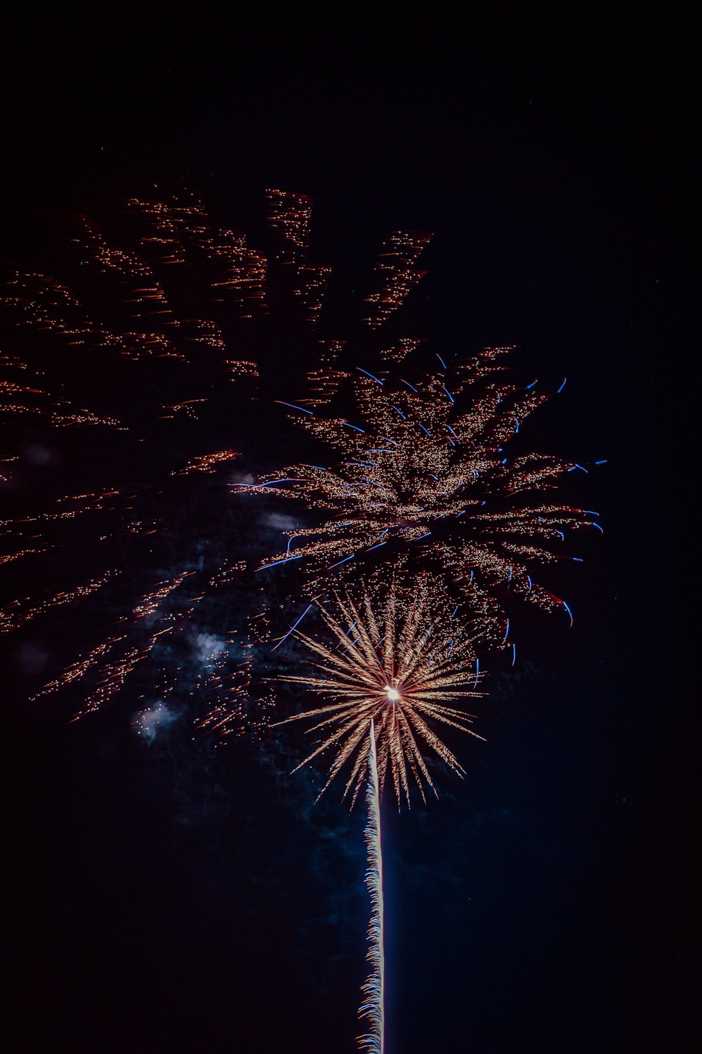 a fireworks display is lit up in the night sky