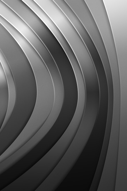 a black and white photo of a curved metal surface