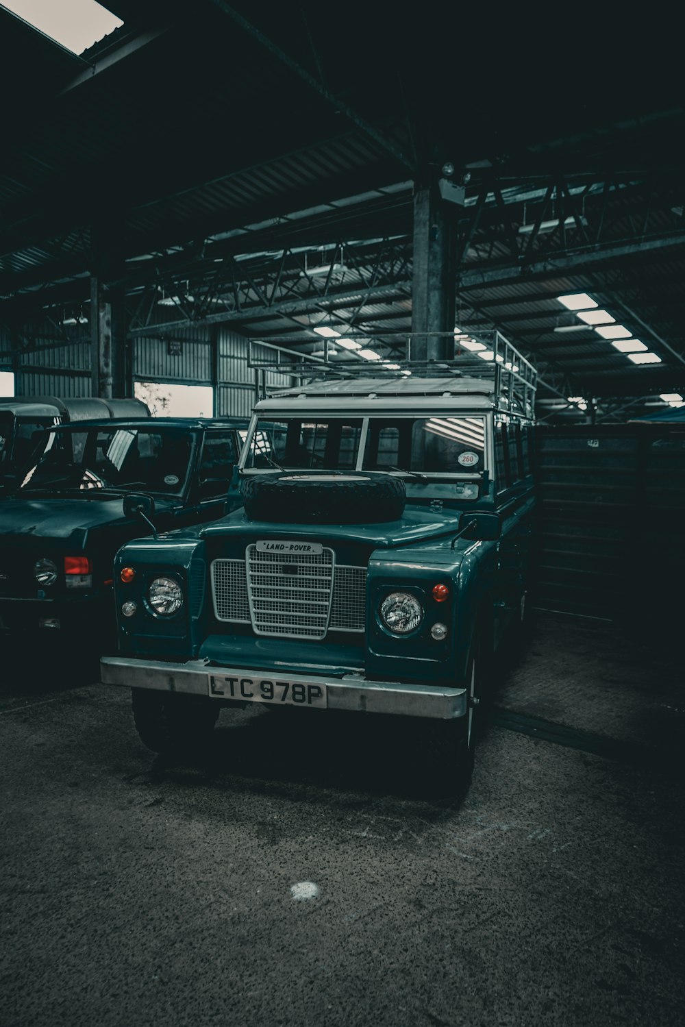 a couple of trucks are parked in a garage