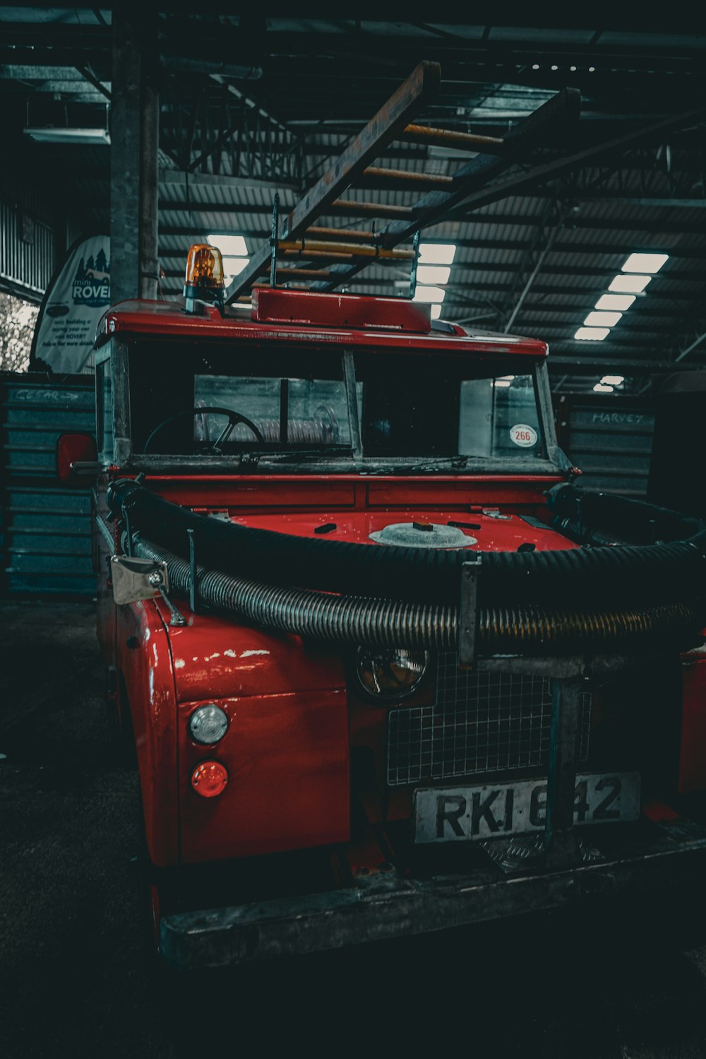 a red truck parked inside of a garage