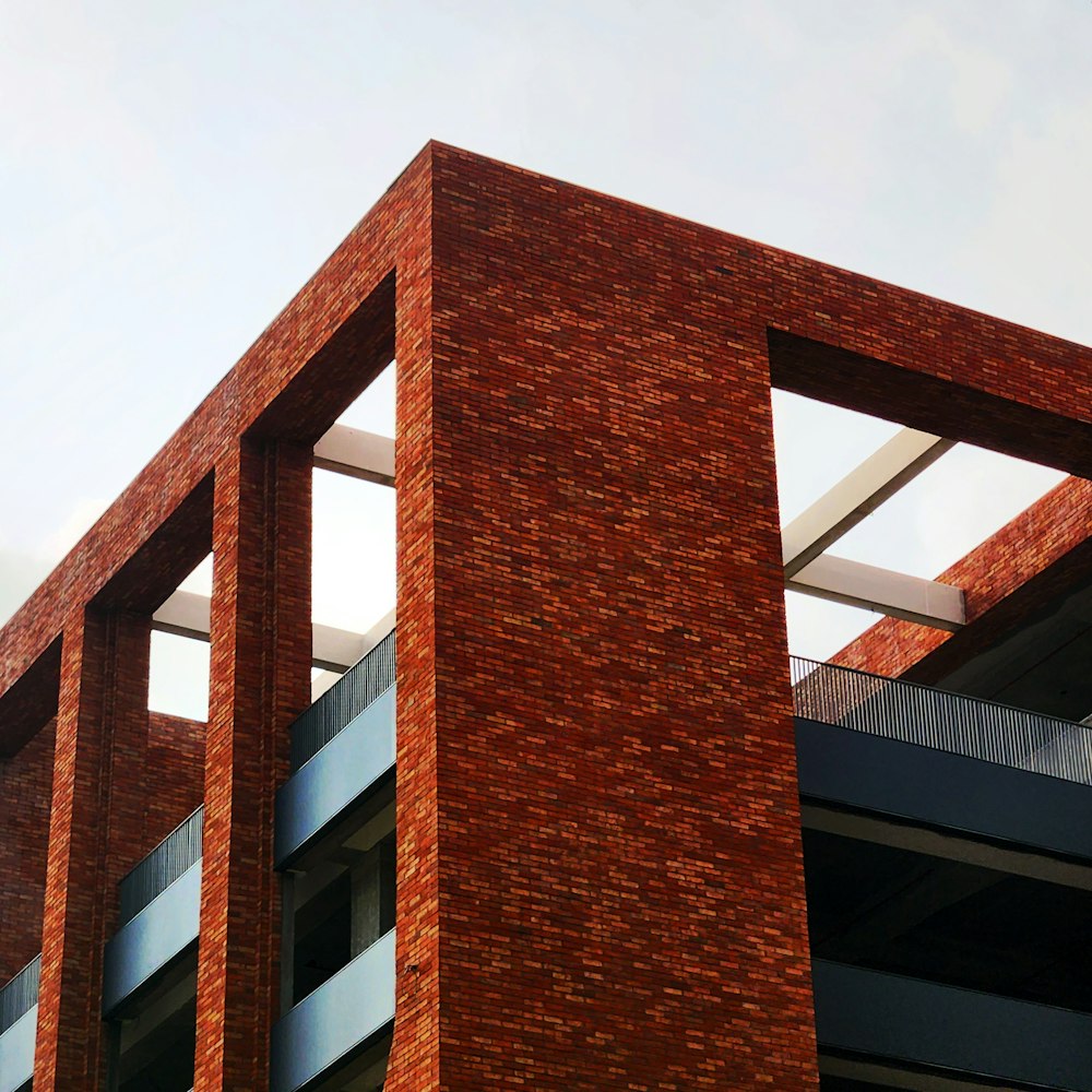 a red brick building with a clock on it's side