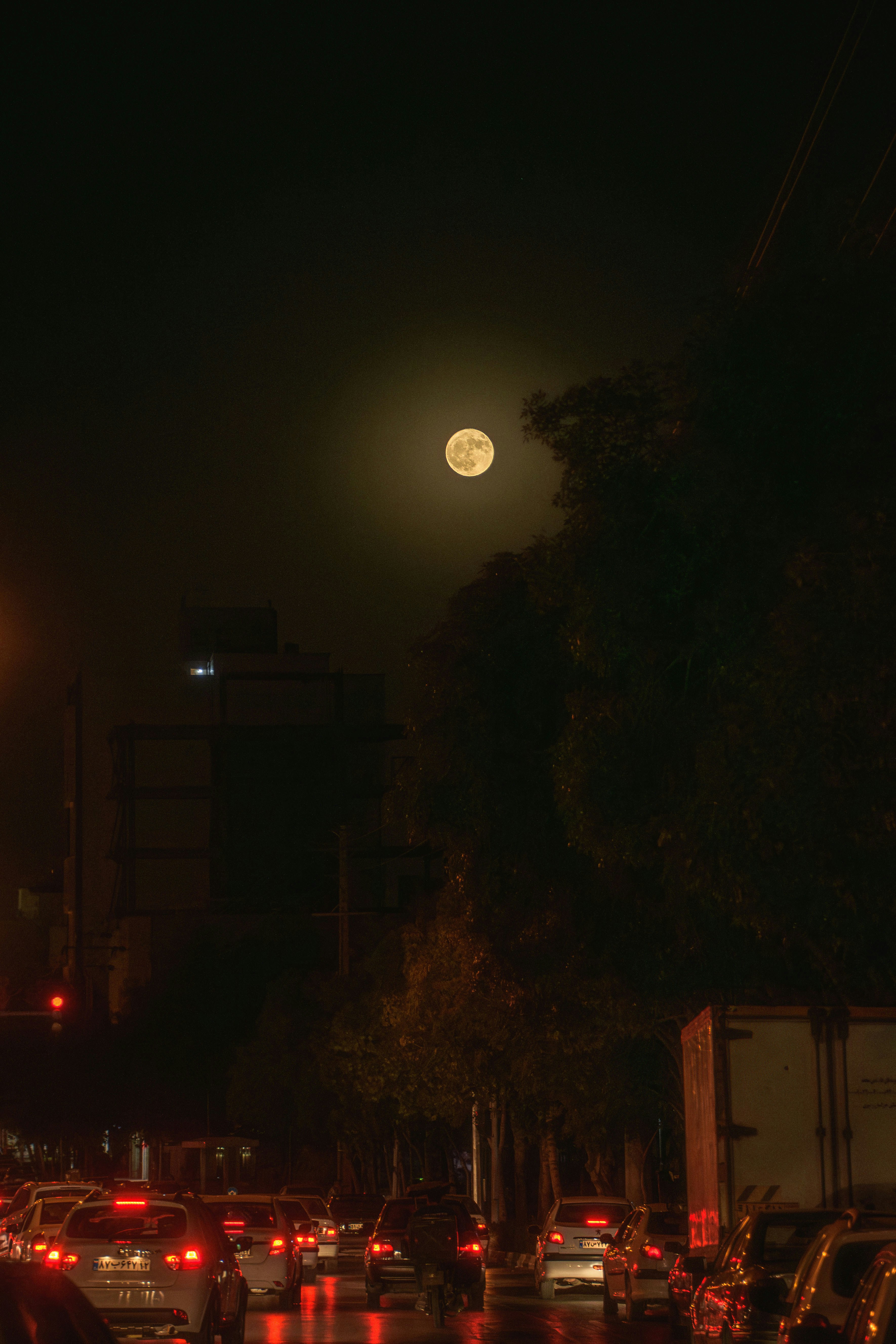 a city street filled with lots of traffic at night