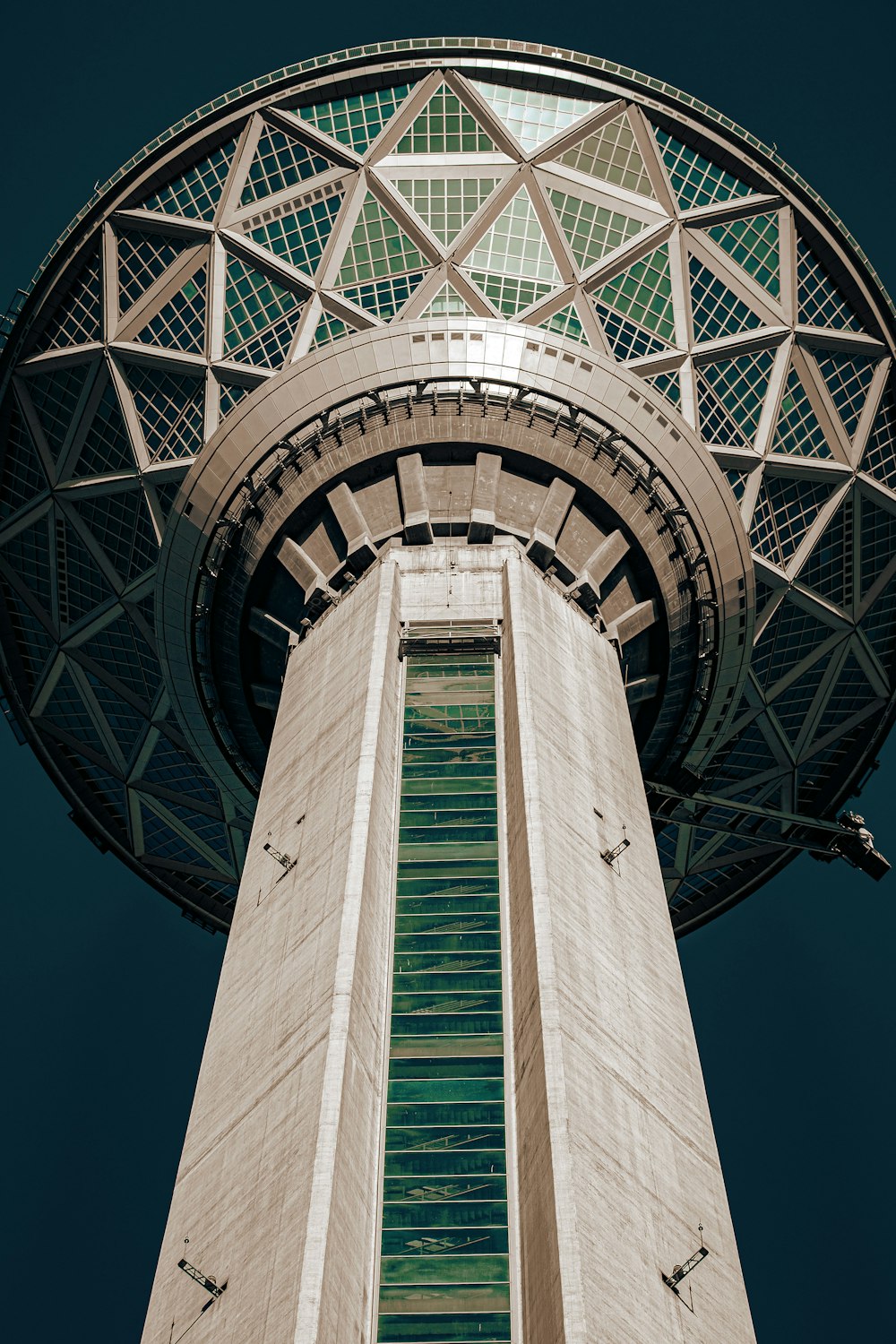 a very tall tower with a very tall clock on it's side