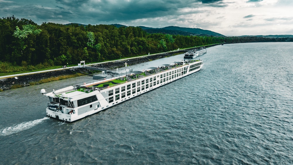 a large white boat traveling down a river