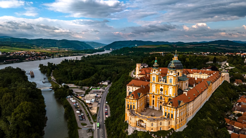 an aerial view of a castle with a river in the background