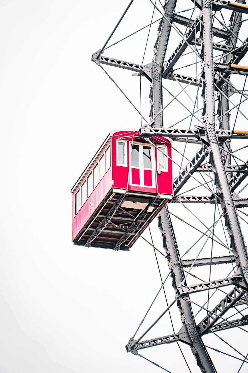 a red chair sitting on top of a metal structure