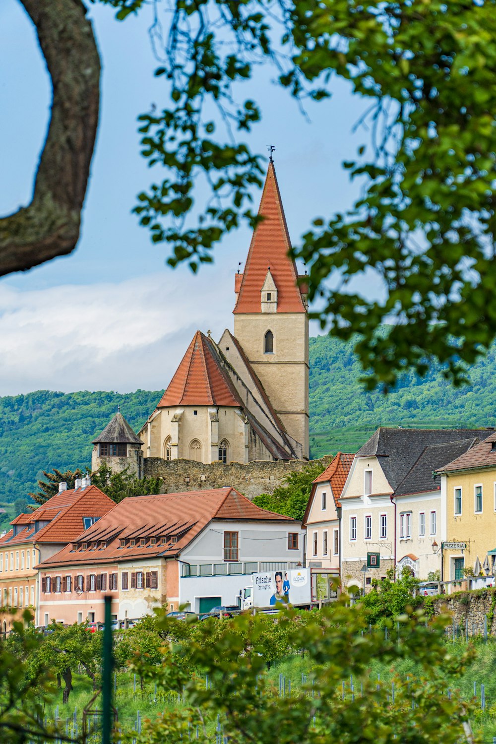 a view of a town with a church on top of a hill