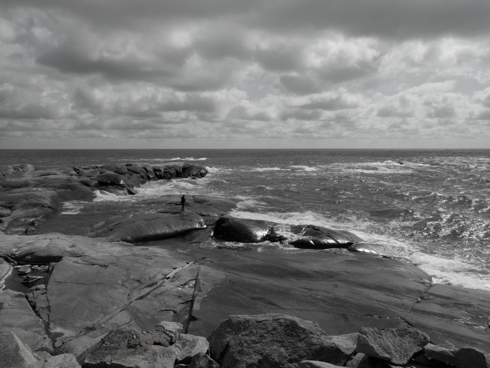 a black and white photo of a rocky beach