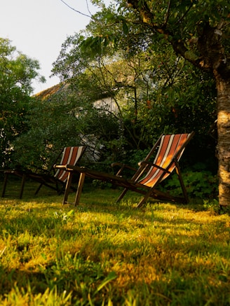 Close-up of weather-resistant garden chairs with cushions on a wooden deck