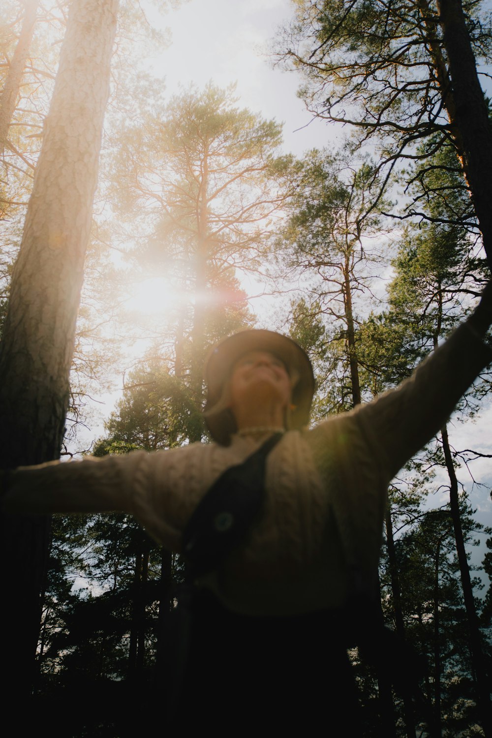 a man standing in the middle of a forest