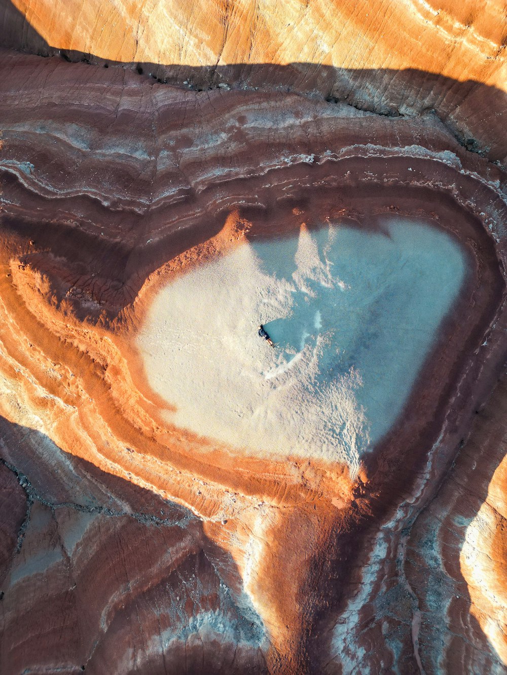 an aerial view of a lake in the desert