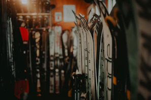 Technician carefully waxing skis in the cozy Glidepeak workshop