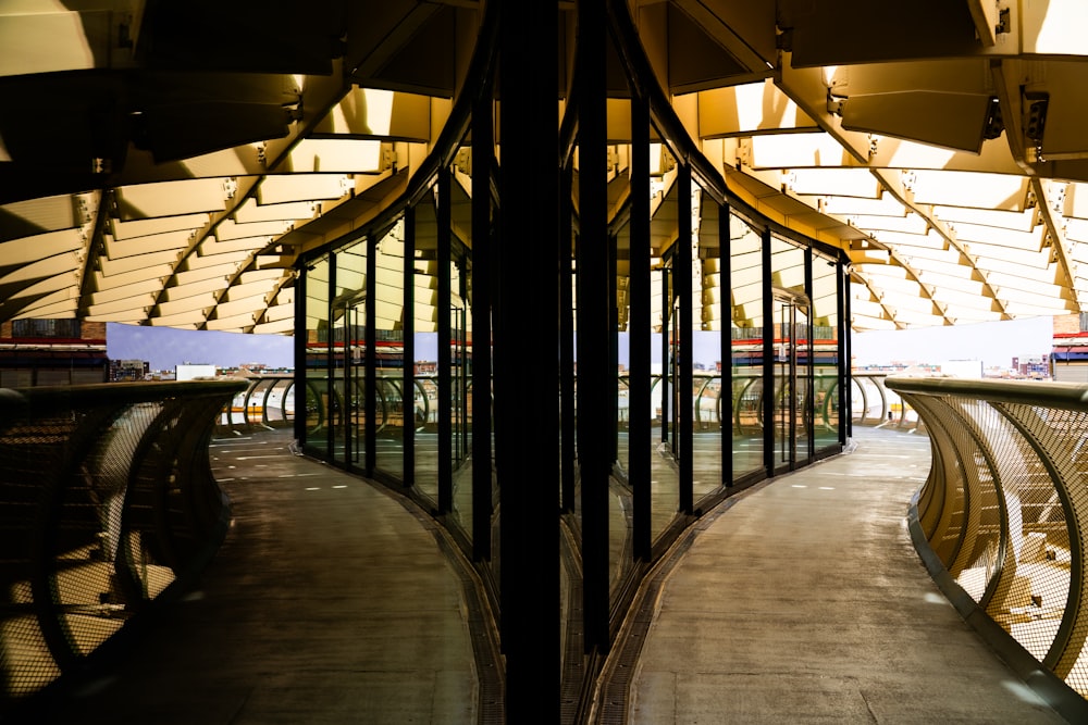 a walkway in a building with glass walls