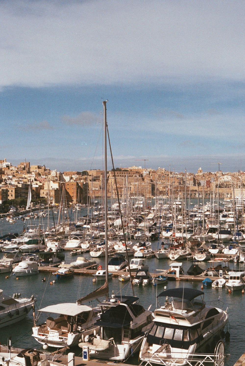 a harbor filled with lots of boats next to a city