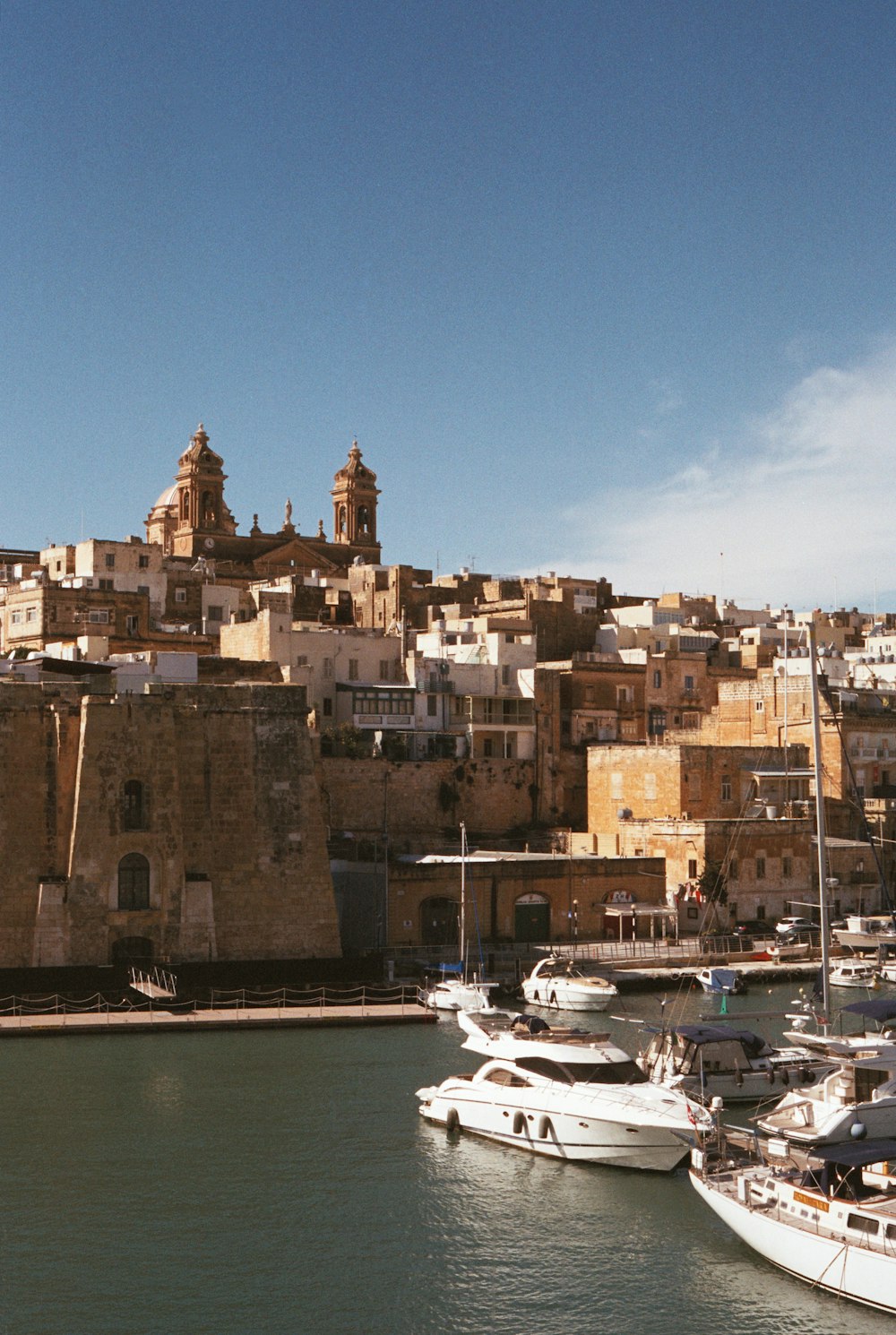 a harbor filled with lots of boats next to a city