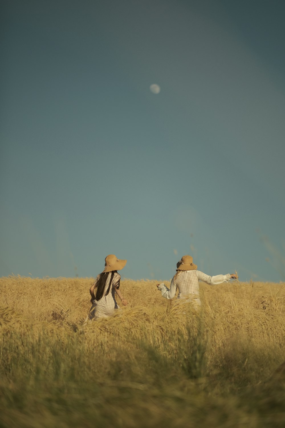 a couple of people that are sitting in a field