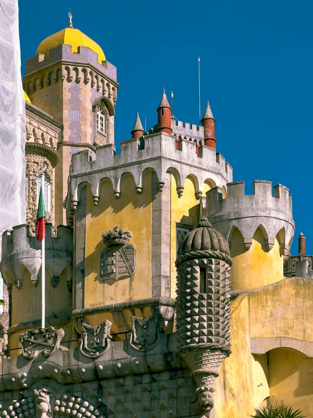 a castle like building with a flag flying in front of it