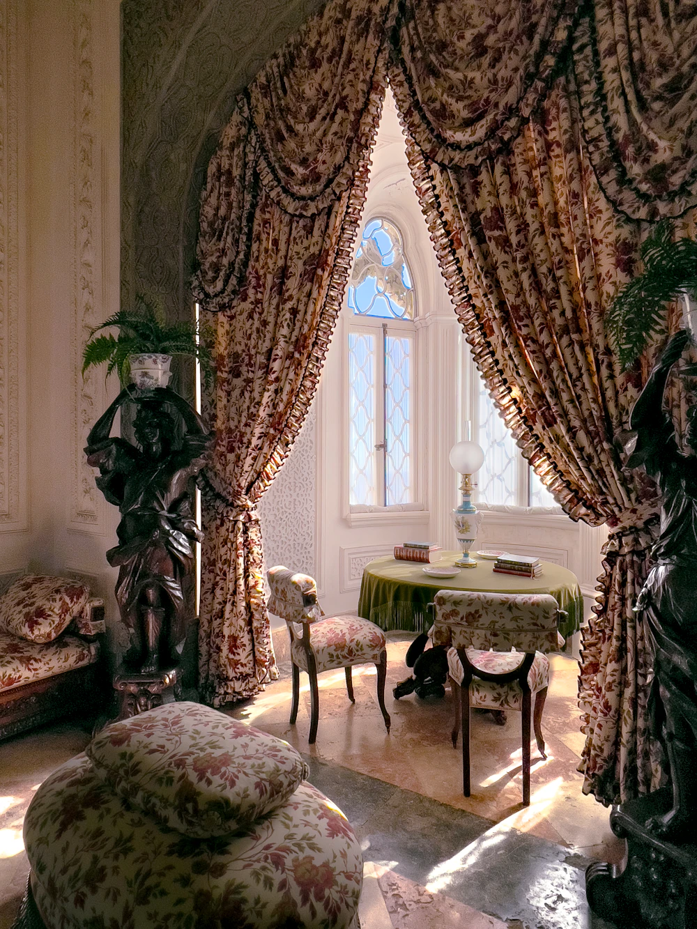 Bright living space with large windows and treatments