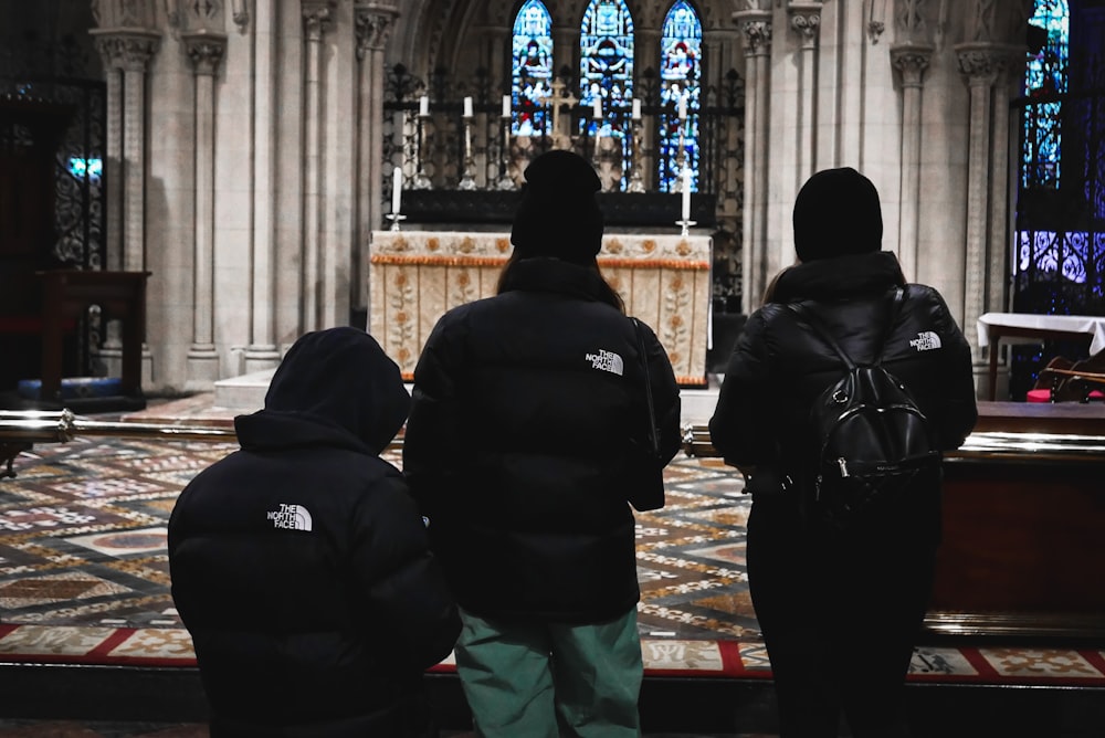 a group of people standing in front of a church