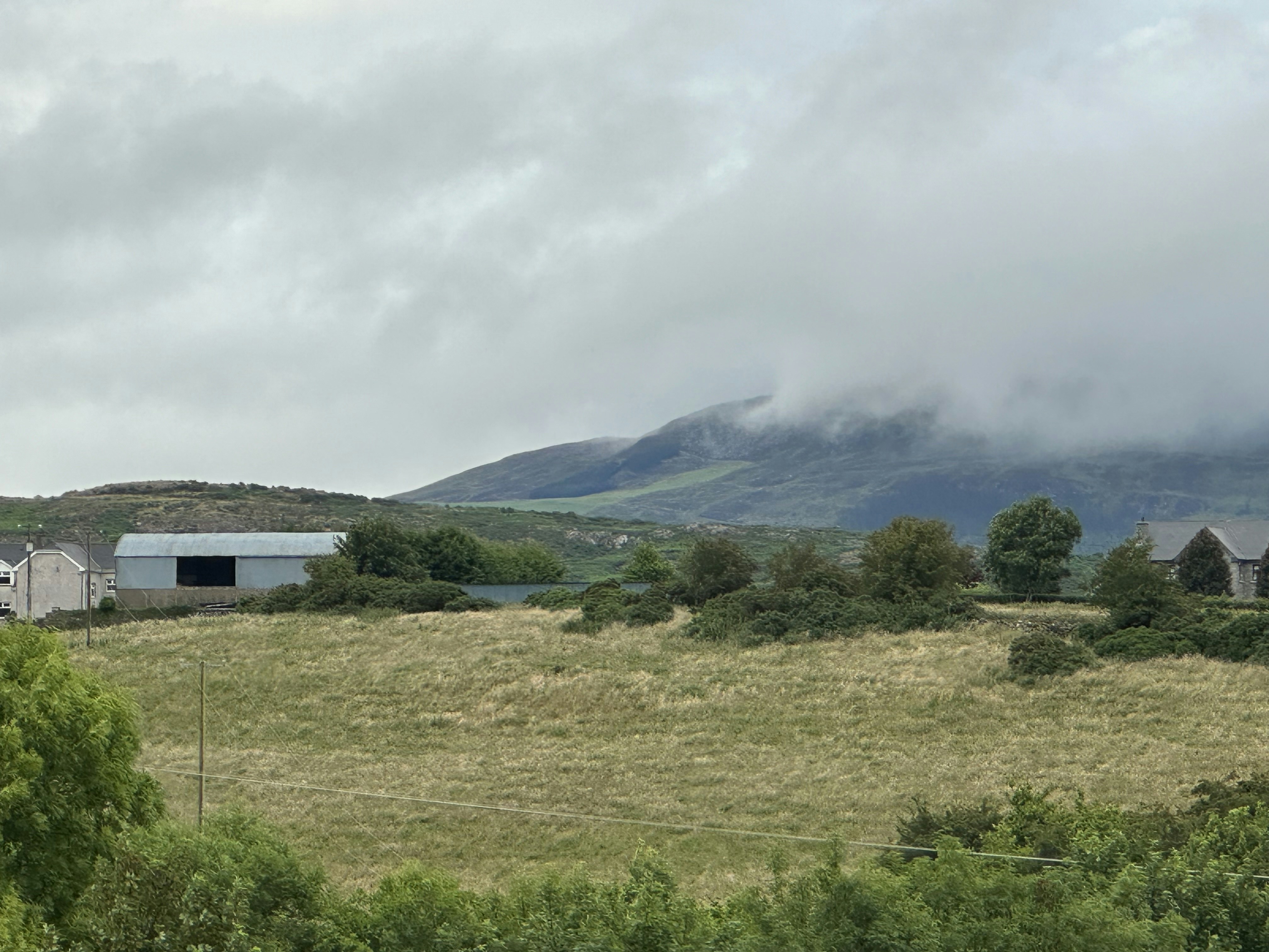 a farm with a barn in the middle of a field