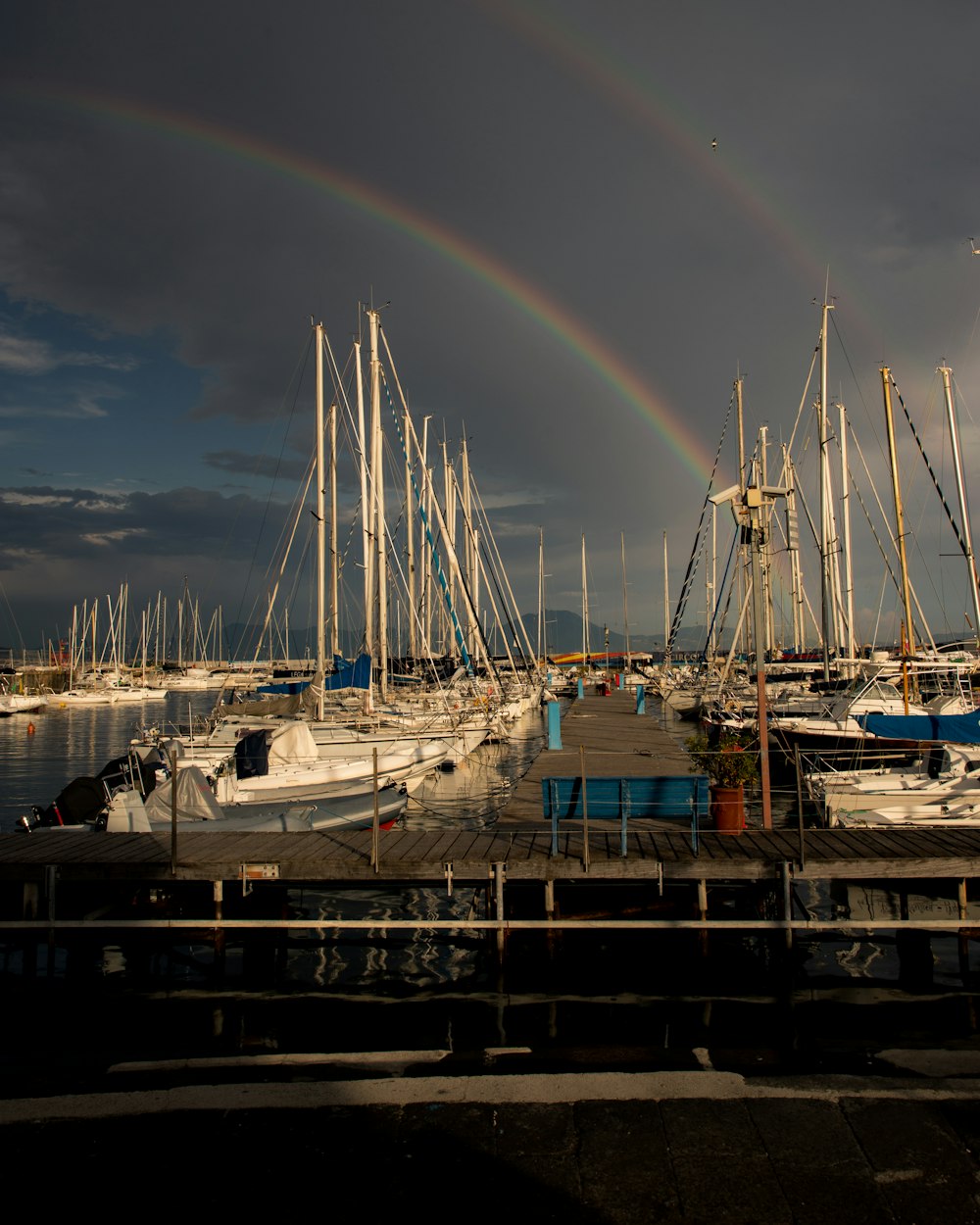 a rainbow in the sky over a marina