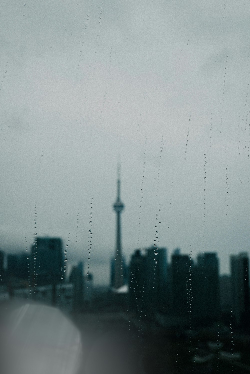 a view of a city through a rainy window
