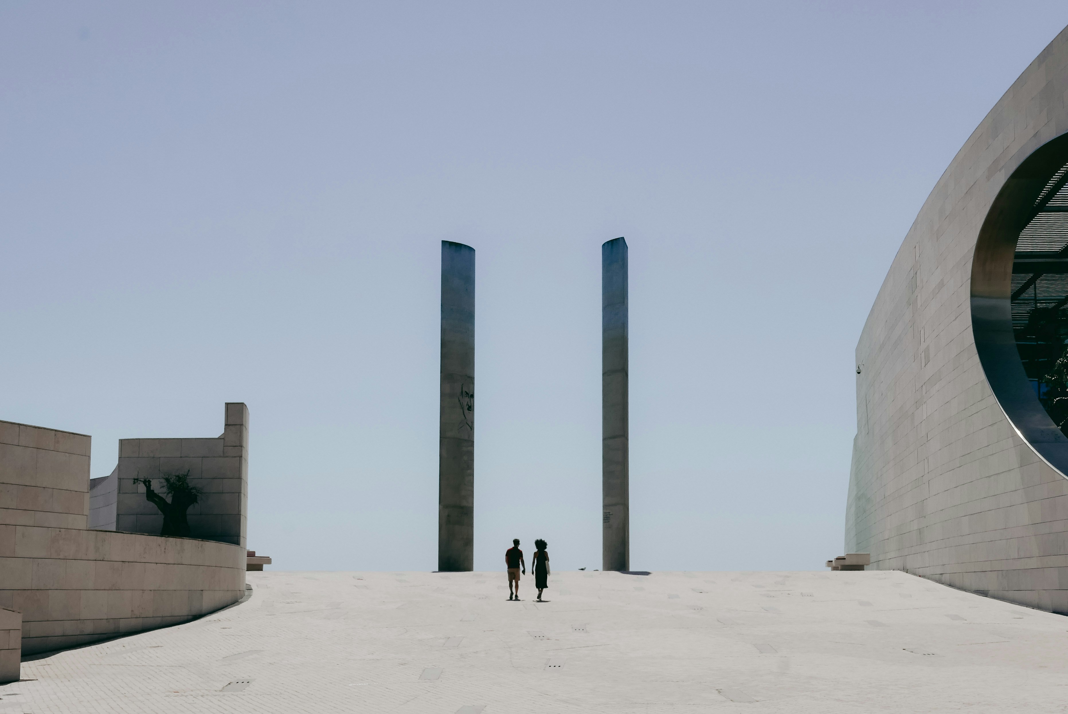 a couple of people that are standing in the sand
