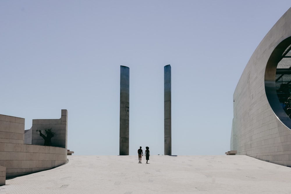 a couple of people that are standing in the sand