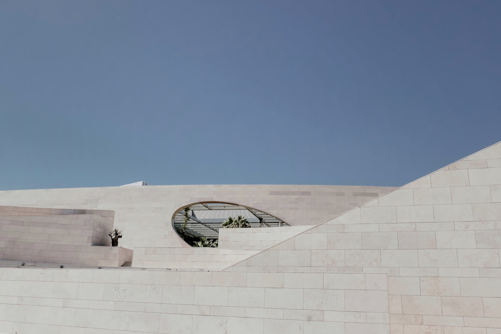 a white building with a circular window on the side of it