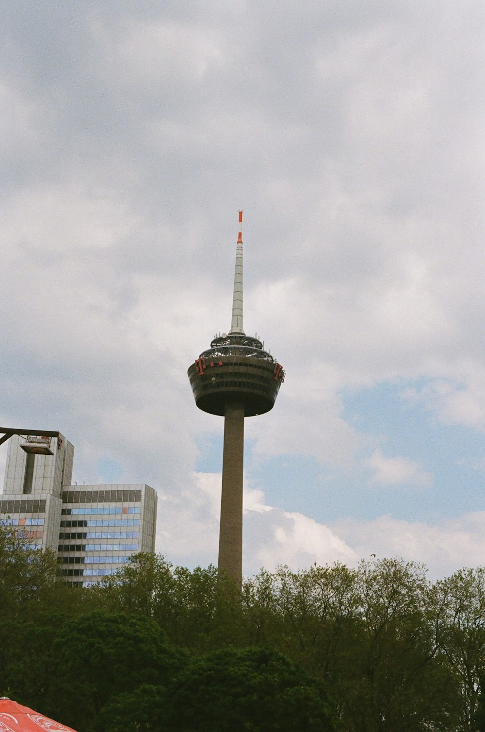 a tall tower with a sky scraper in the background